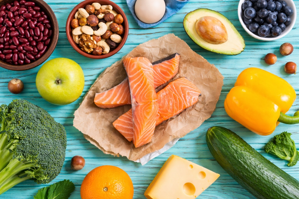 Healthy foods including salmon, broccoli, avocado, and blueberries